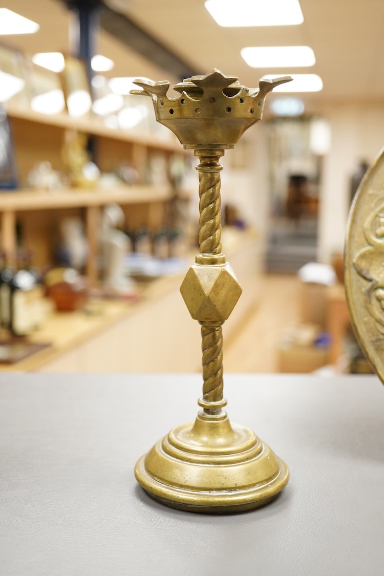 A pair of Pugin style ‘gothic’ brass candlesticks - 21cm high and a circular brass disc depicting Hercules and The Nemean Lion - 25cm in diameter